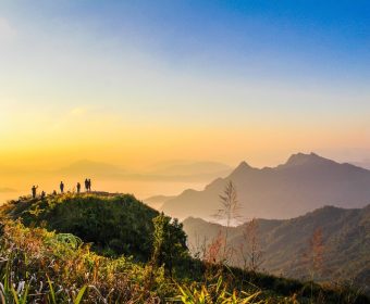 photo-of-people-standing-on-top-of-mountain-near-grasses-733162.jpg